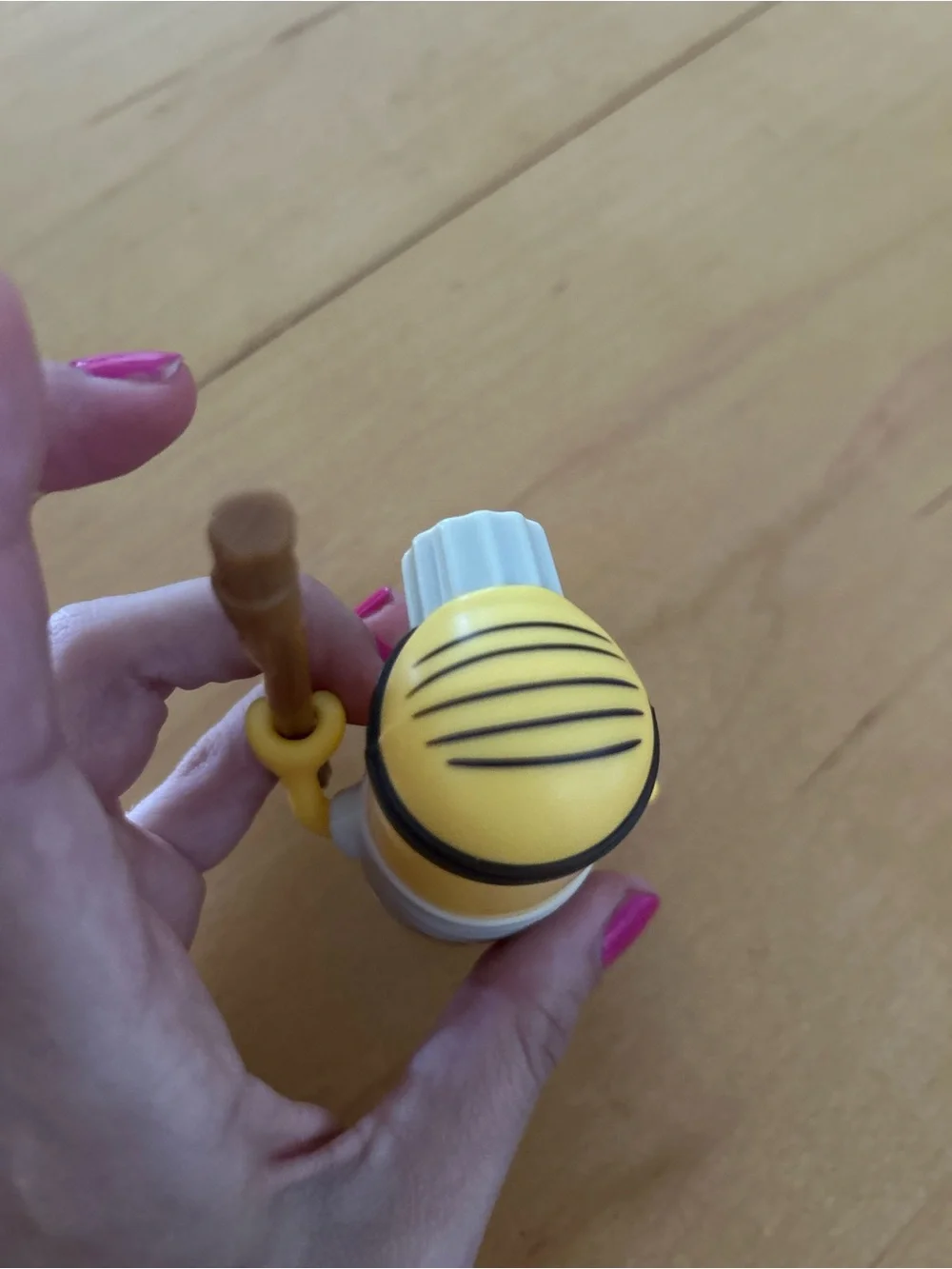 One-Eyed Yellow Action Figure with Brown Staff - Classic Cartoon Style